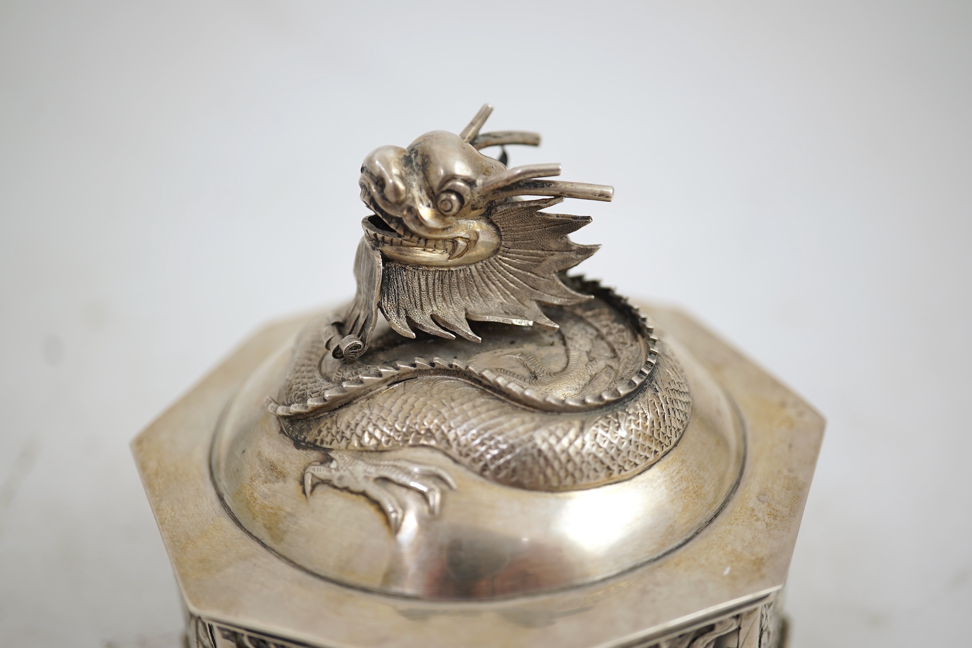 A late 19th century Chinese Export pierced silver card case, maker KMS(Kwong Man Shing), decorated with dragons amid clouds, 10.4cm, together with a Chinese Export pierced silver octagonal box and cover, by Luen Wo?, cir